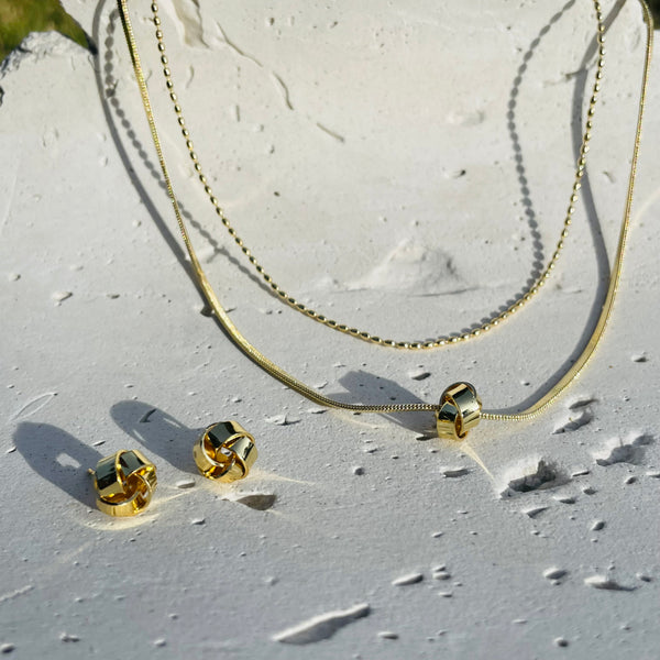 set dos niveles con aretes rodio 