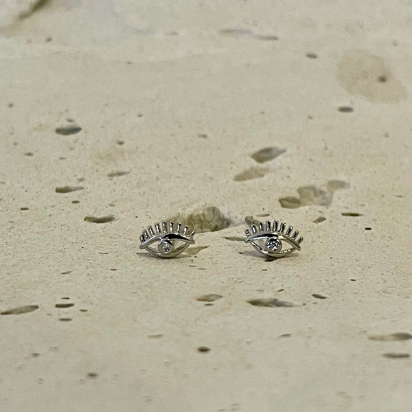 Mujer luciendo topos Nazar ojo turco - Aretes protectores simbólicos 
