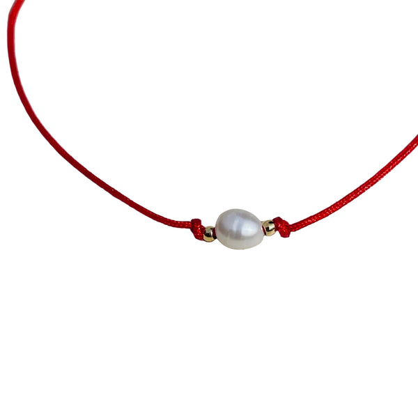 pulsera perla de agua en hilo rojo amuleto