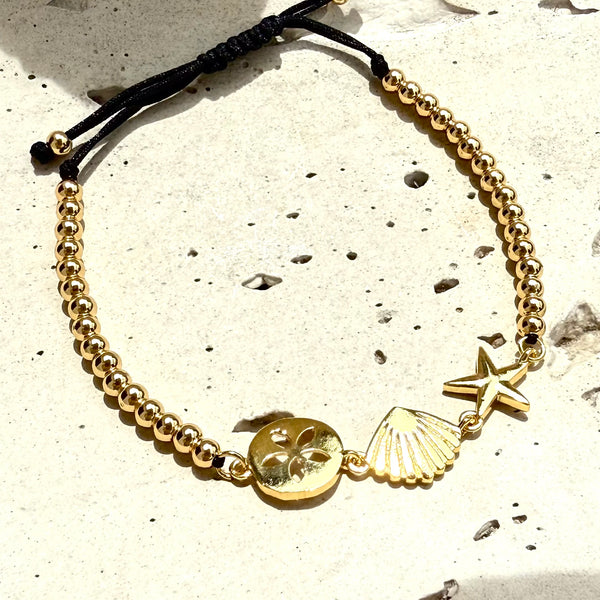 pulsera ajustable con dijes en concha 