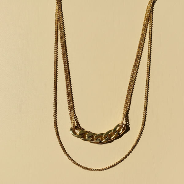 Detalle cadena gruesa central estilo Cartier collar doble nivel acero dorado MariaBolo, textura premium hipoalergénico duradero
